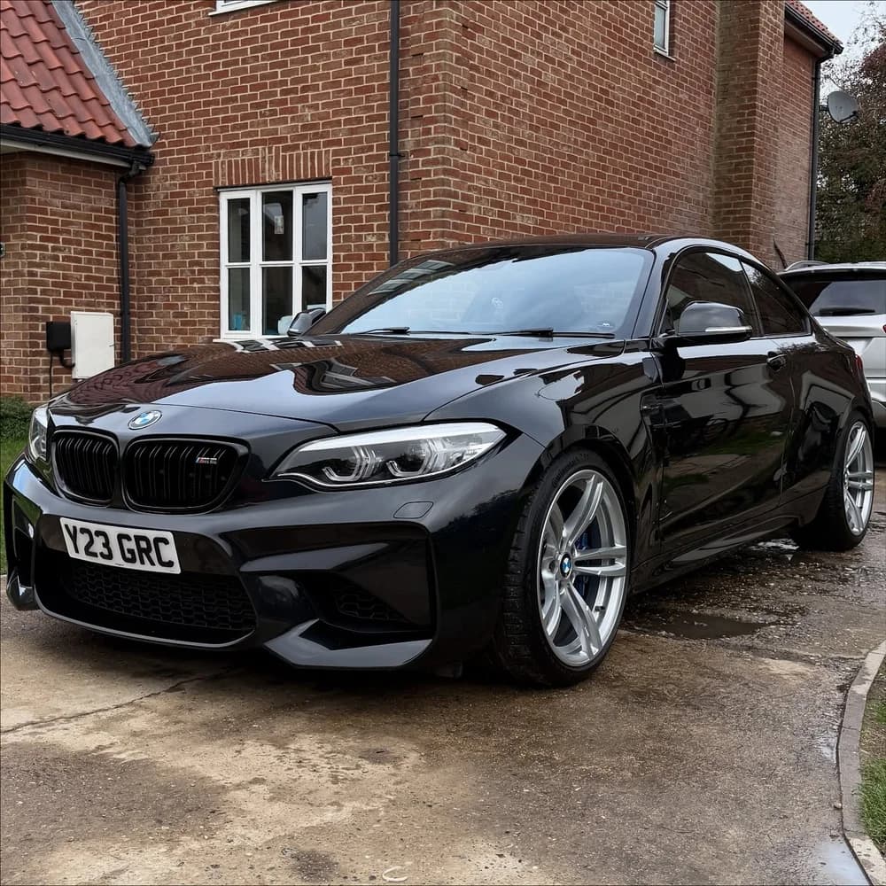 Black BMW M2 gleaming after a mobile valet